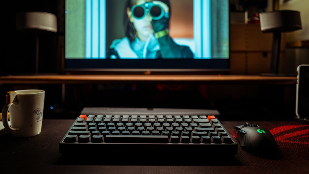 black flat screen computer monitor turned on displaying man in black sunglasses