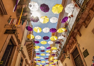 pink and white umbrella hanging on the street