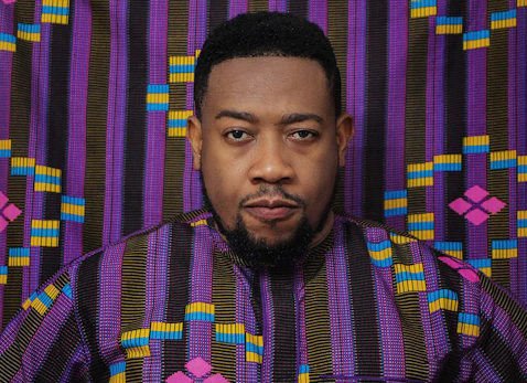 man in purple and black plaid turtle neck shirt