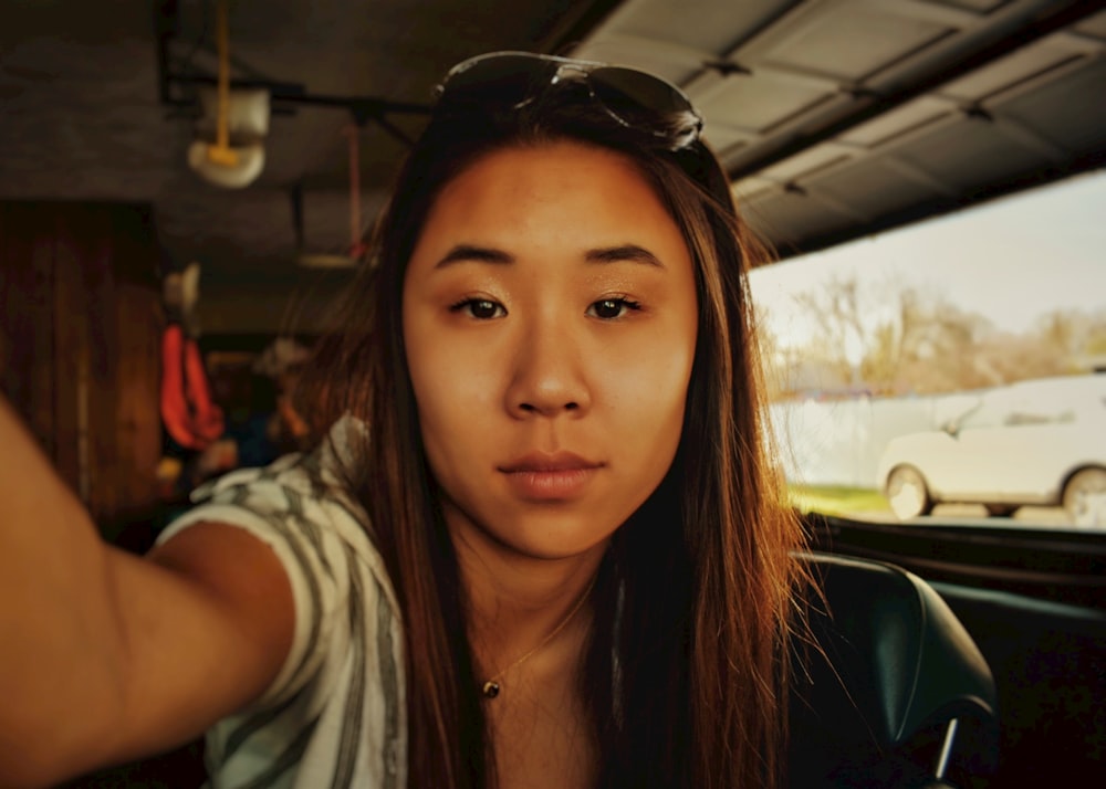 woman in gray shirt wearing black headphones