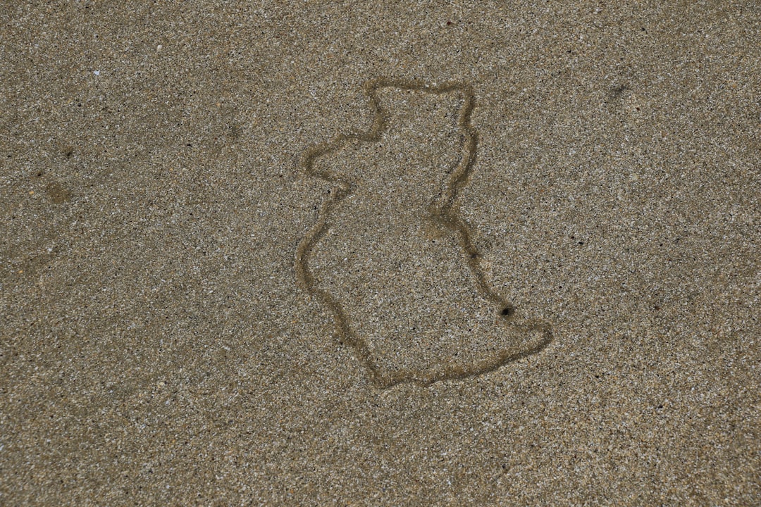 heart drawing on gray sand