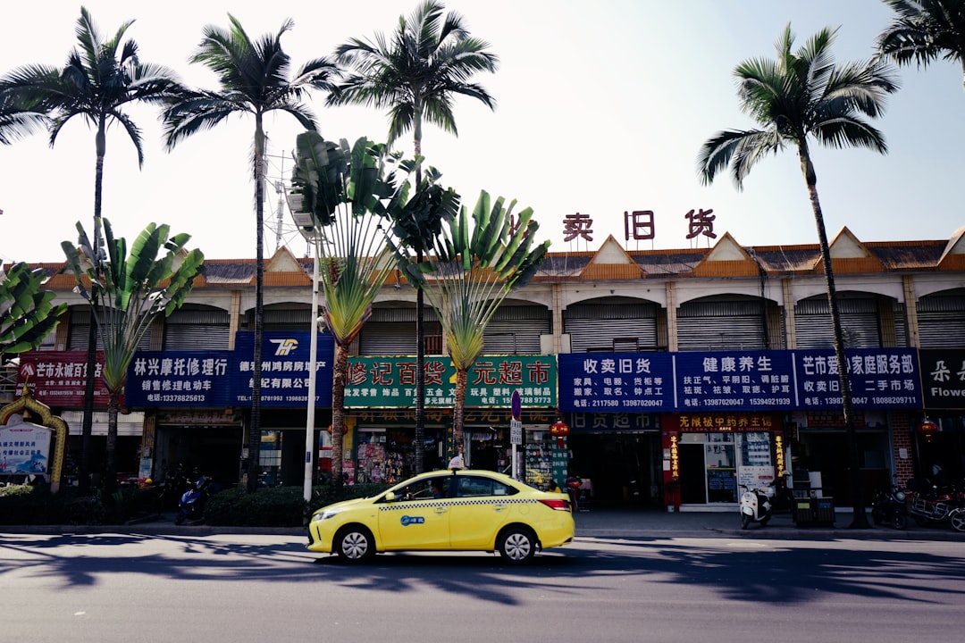 yellow car parked in front of brown concrete building during daytime