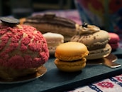 A variety of colorful pastries displayed invitingly on a rustic table.