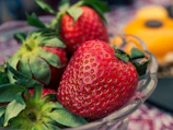 red strawberries on clear glass bowl