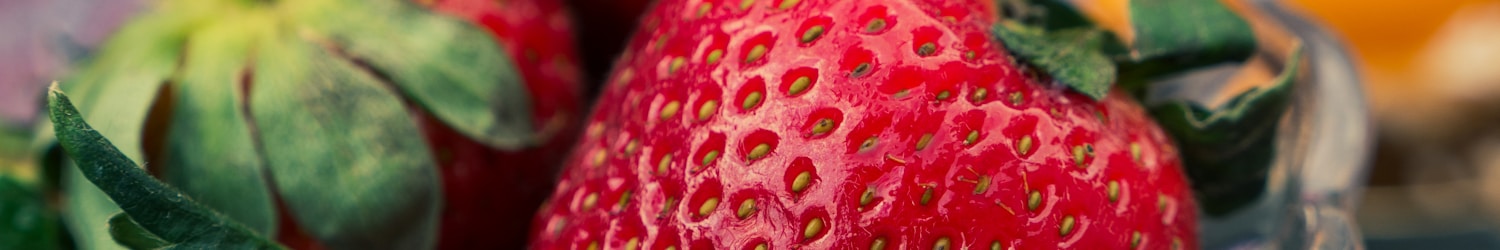 red strawberries on clear glass bowl