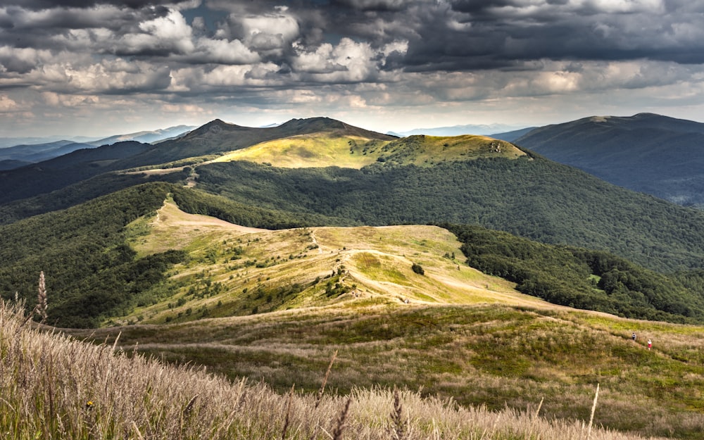 green and brown mountain under gray clouds