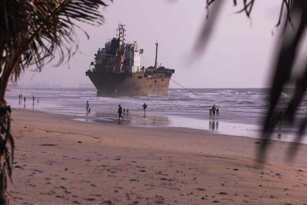 blue ship on sea shore during daytime