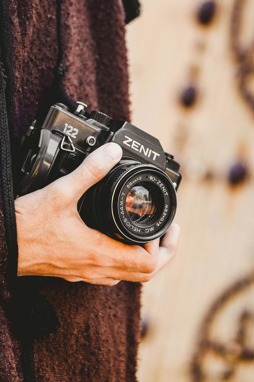 person holding black nikon dslr camera