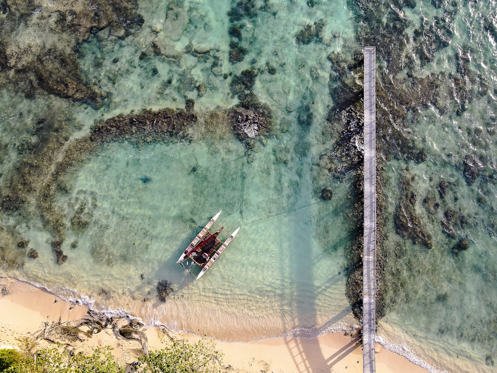 aerial view of boat on sea shore during daytime