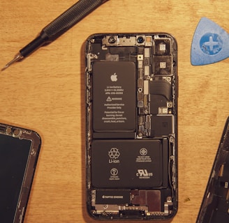 black smartphone on brown wooden table