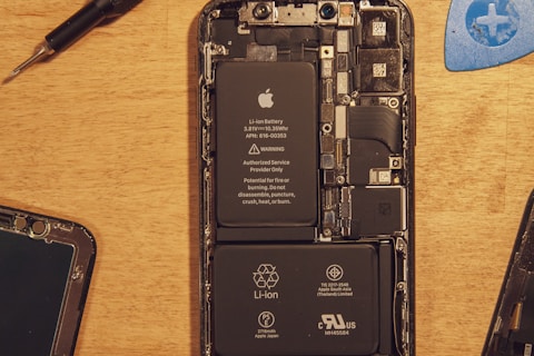 black smartphone on brown wooden table