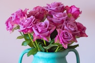 Vibrant mix of fresh Ecuadorian roses and greenery displayed in a stylish ceramic pot.