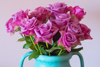 Vibrant mix of fresh Ecuadorian roses and greenery displayed in a stylish ceramic pot.