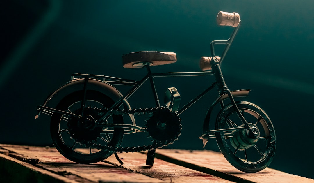 black city bike on brown sand during daytime