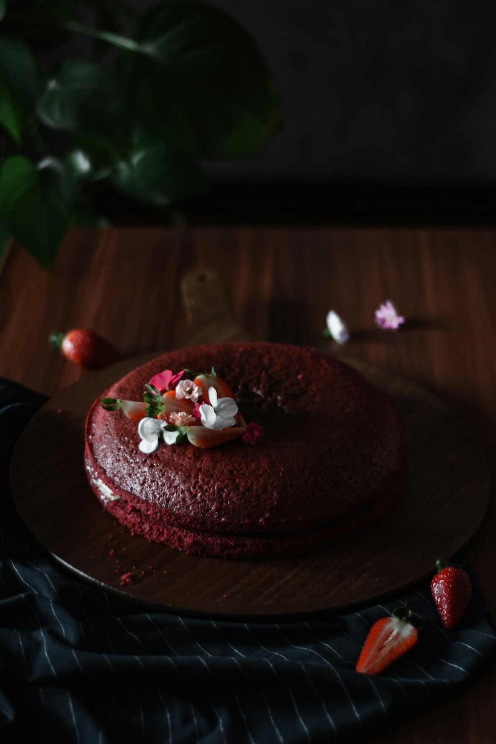 chocolate cake with white icing on brown wooden table