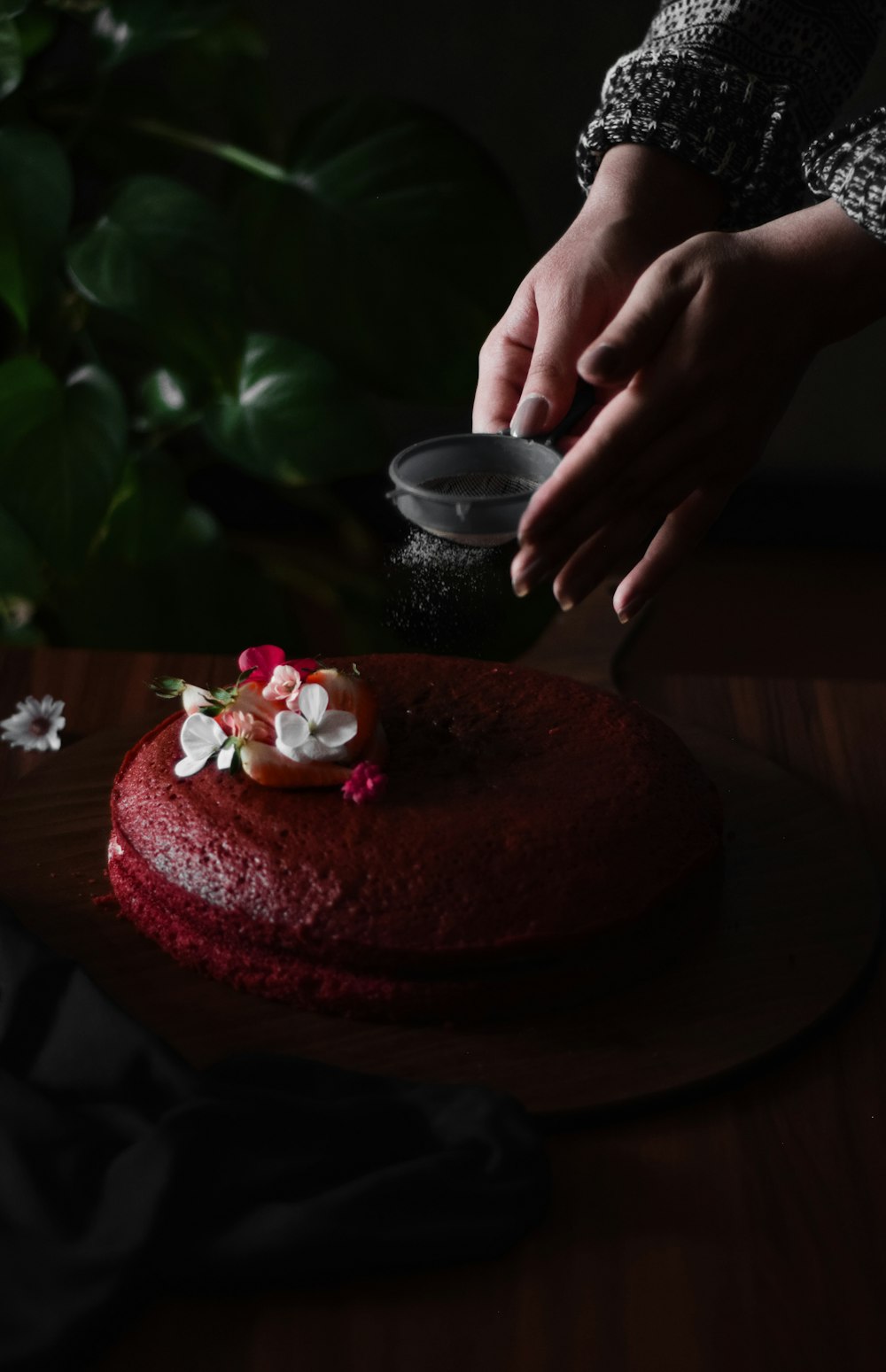 person holding pink and white cake