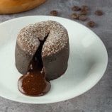 A beautifully decorated chocolate lava cake with molten center oozing out