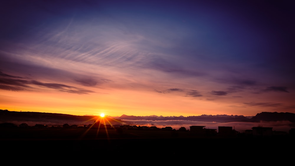 silhouette of buildings during sunset