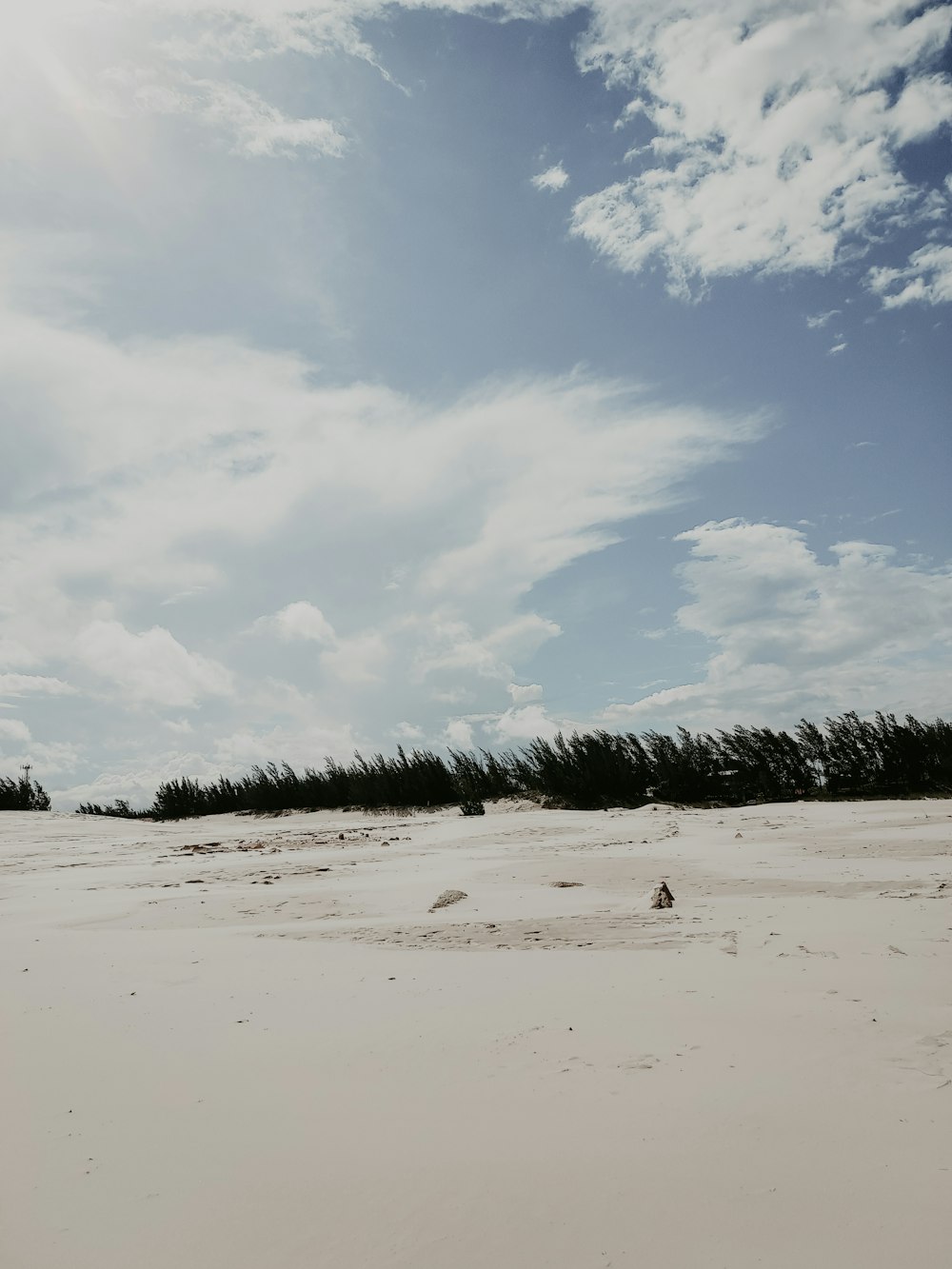 white sand under white clouds during daytime