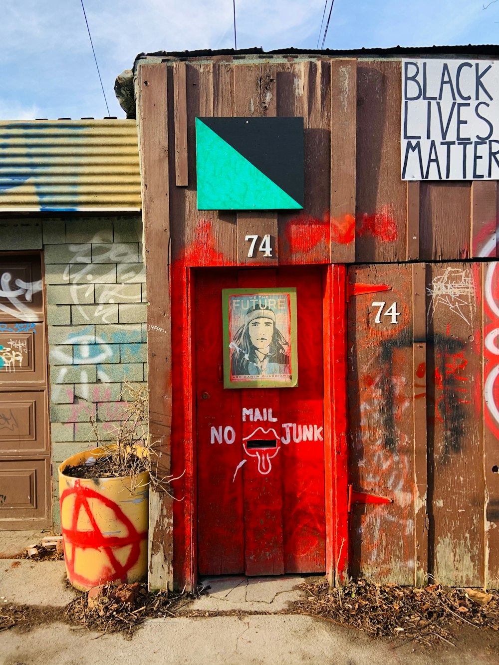 red telephone booth beside brown wooden door