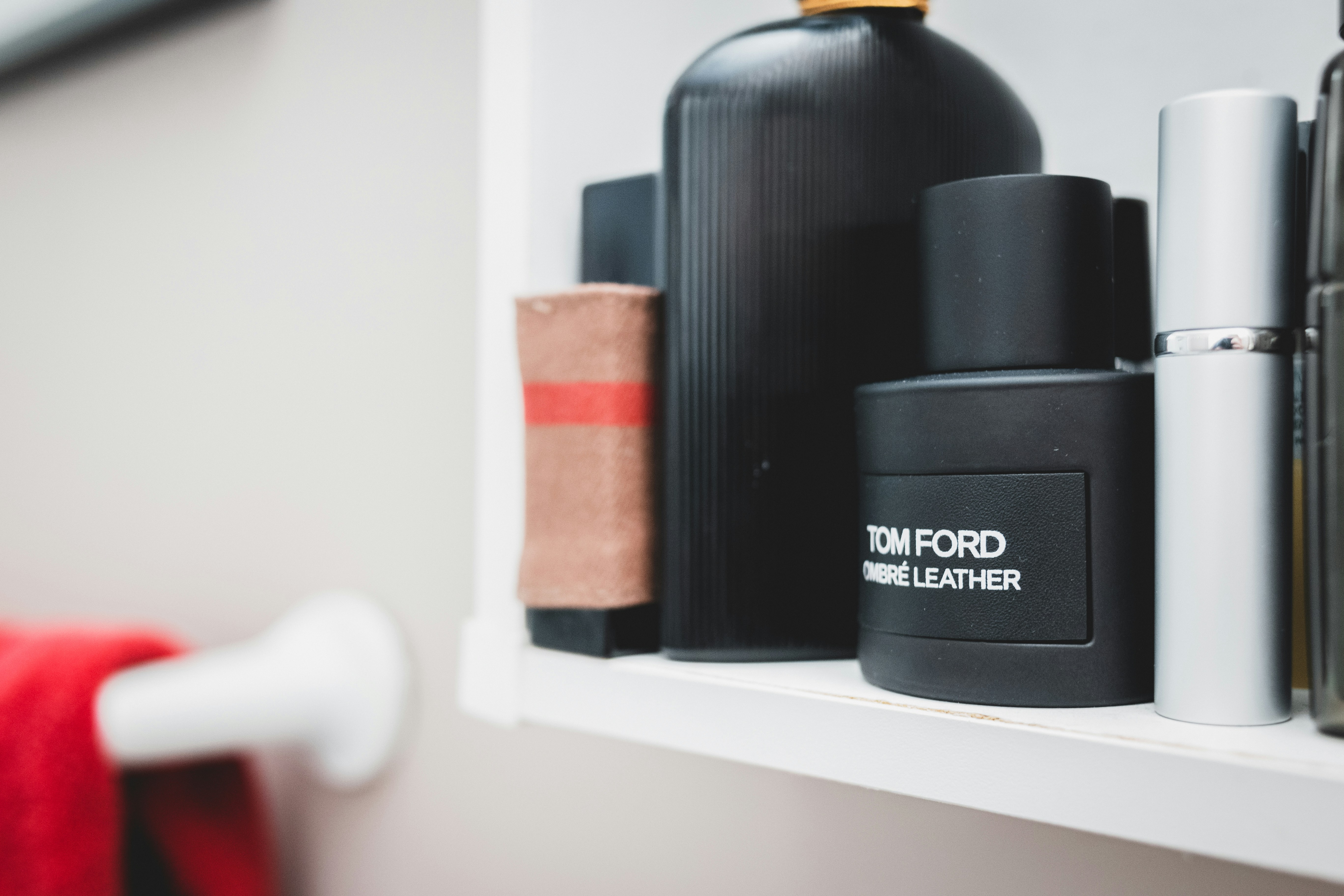 black and white plastic bottle on white wooden shelf