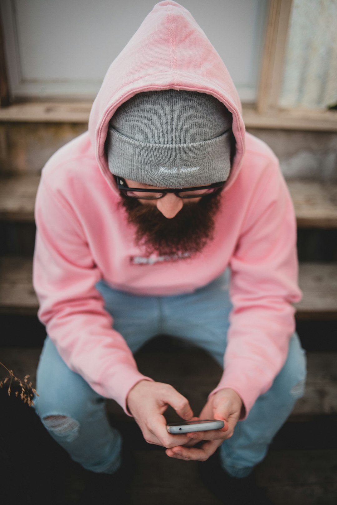 man in pink sweater and gray knit cap