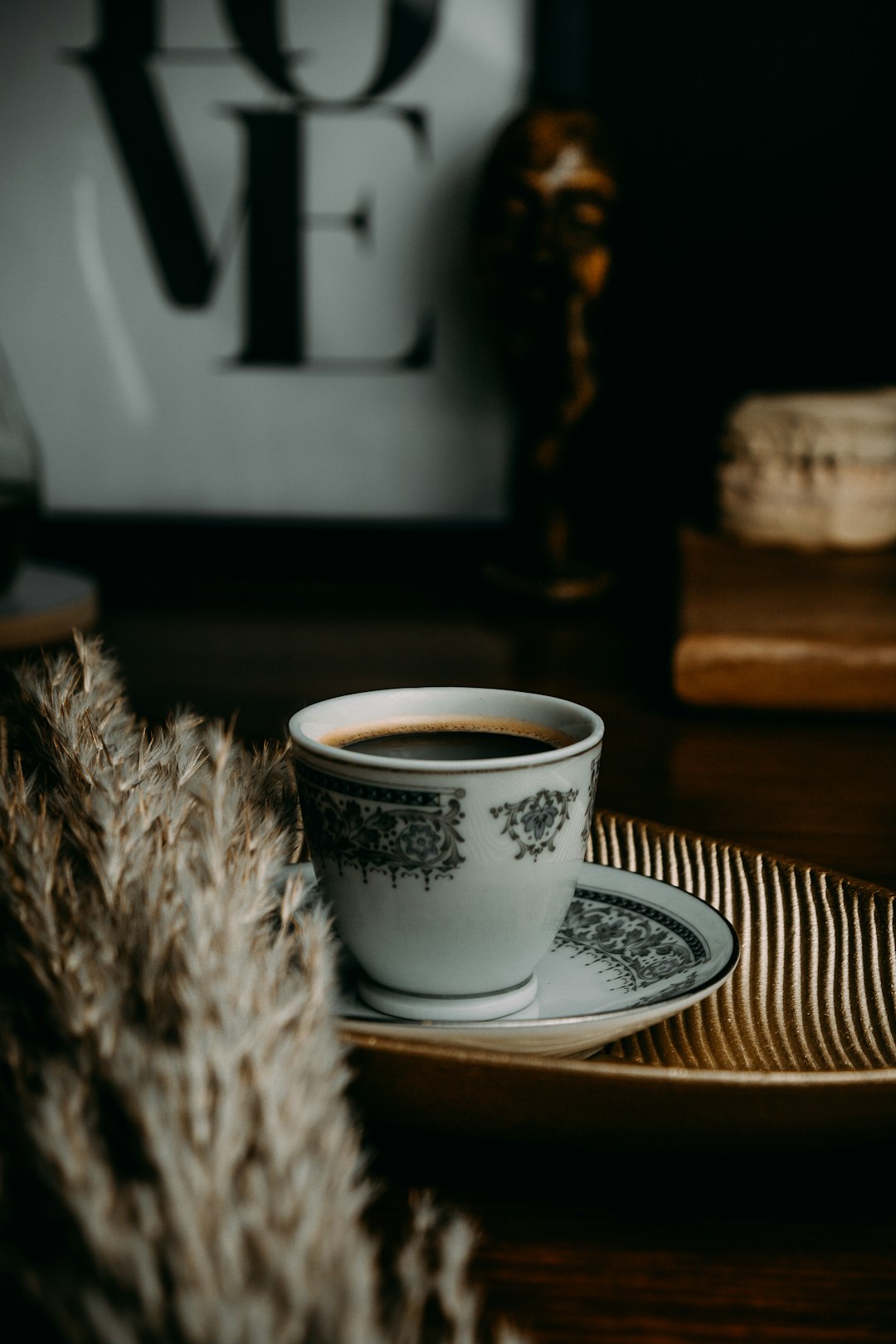 white and black ceramic cup on white ceramic saucer