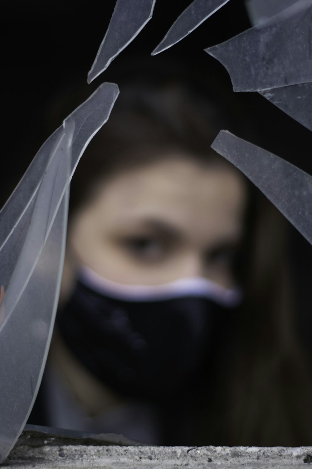 woman covering face with white textile