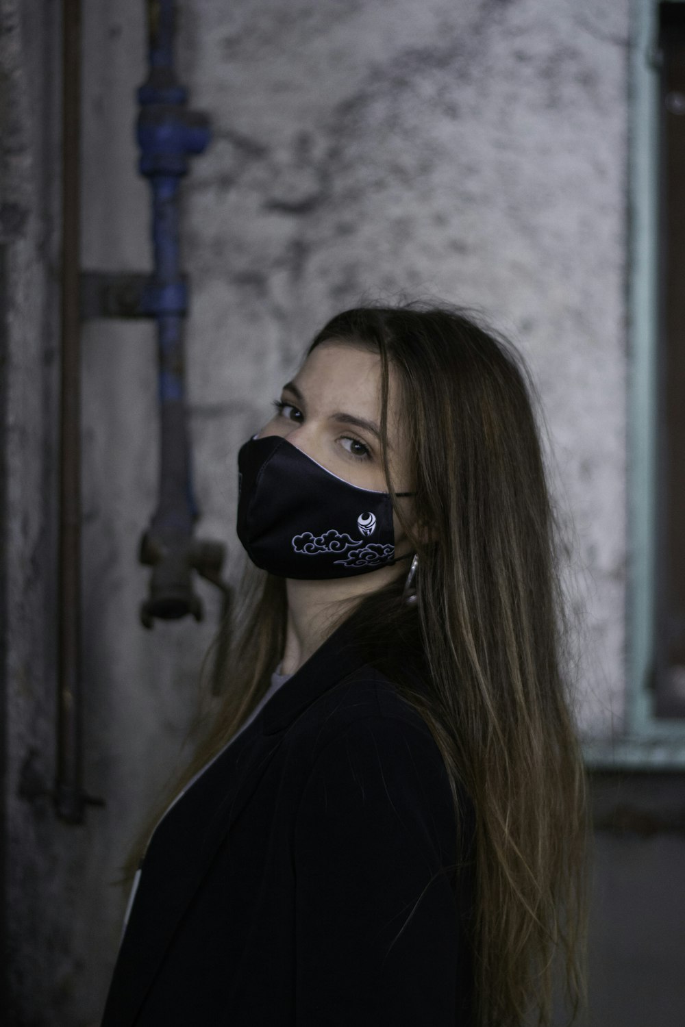 woman in black shirt wearing black and white nike cap