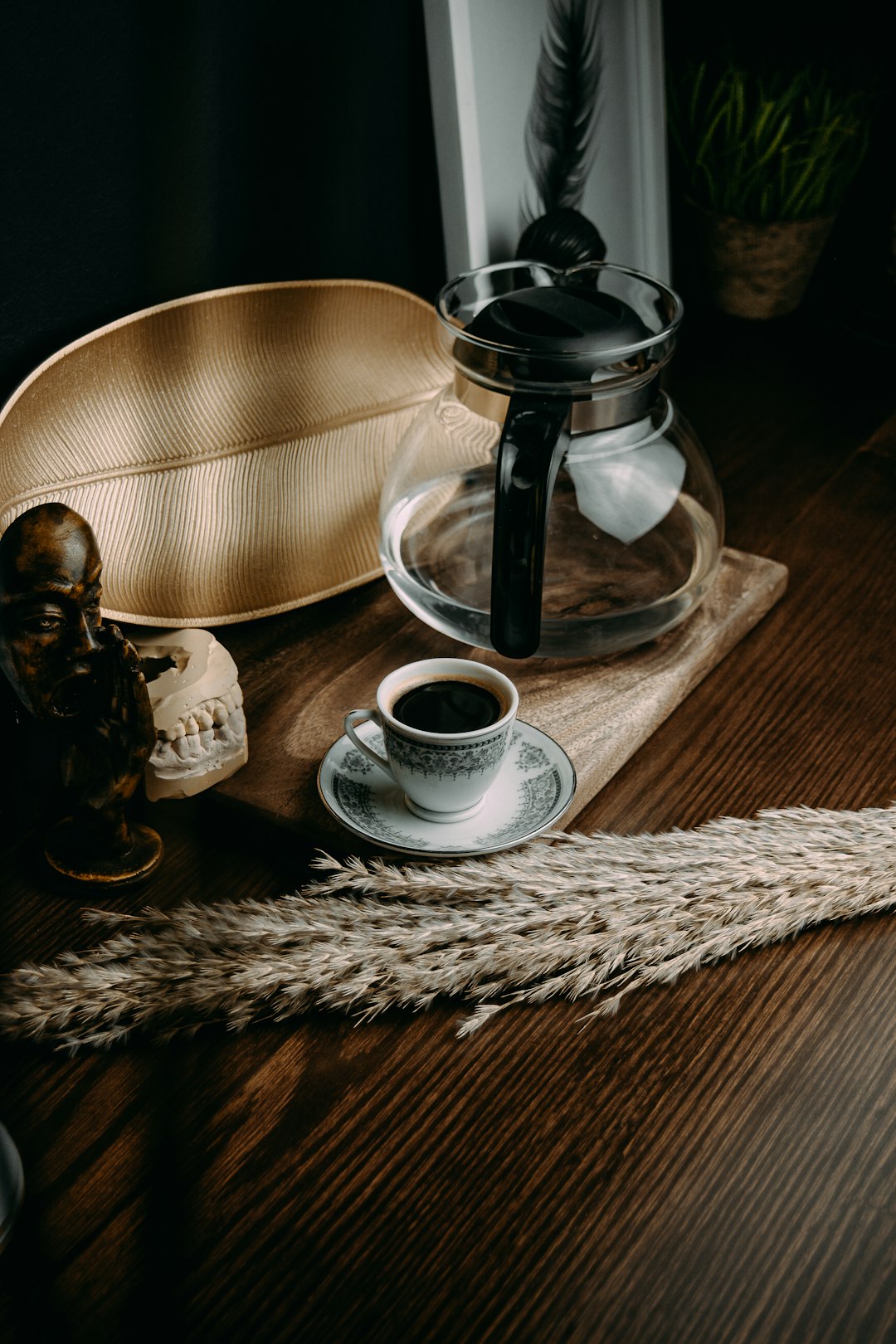 white ceramic teacup on saucer beside clear glass pitcher