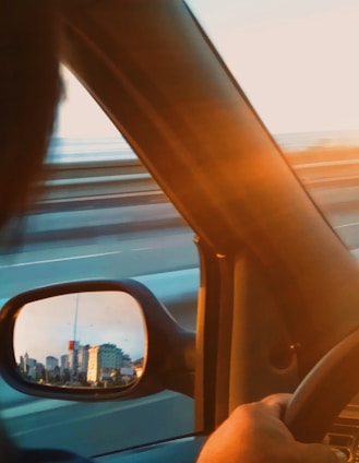 A driver navigating a city street in a modern car during daytime