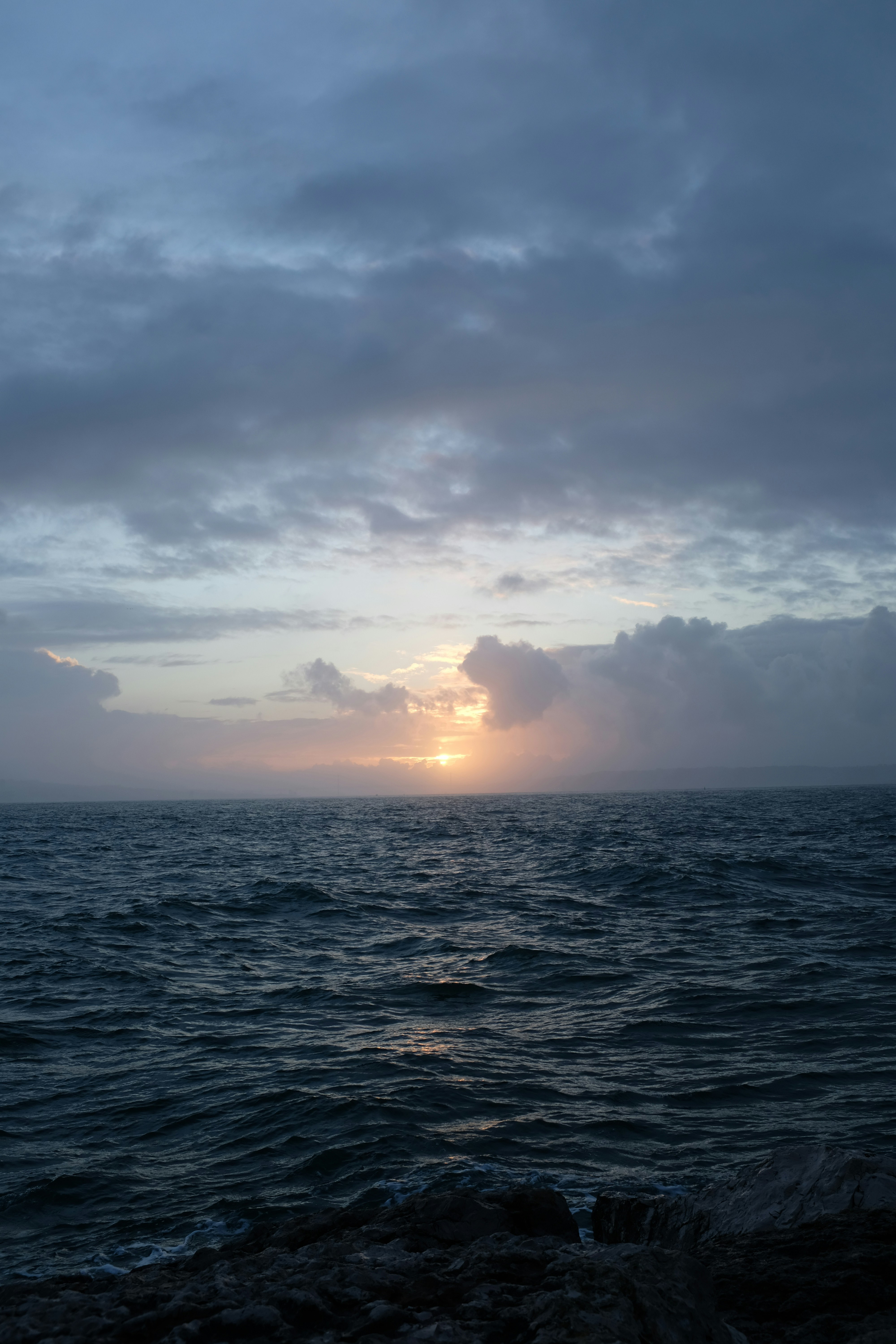 body of water under cloudy sky during daytime