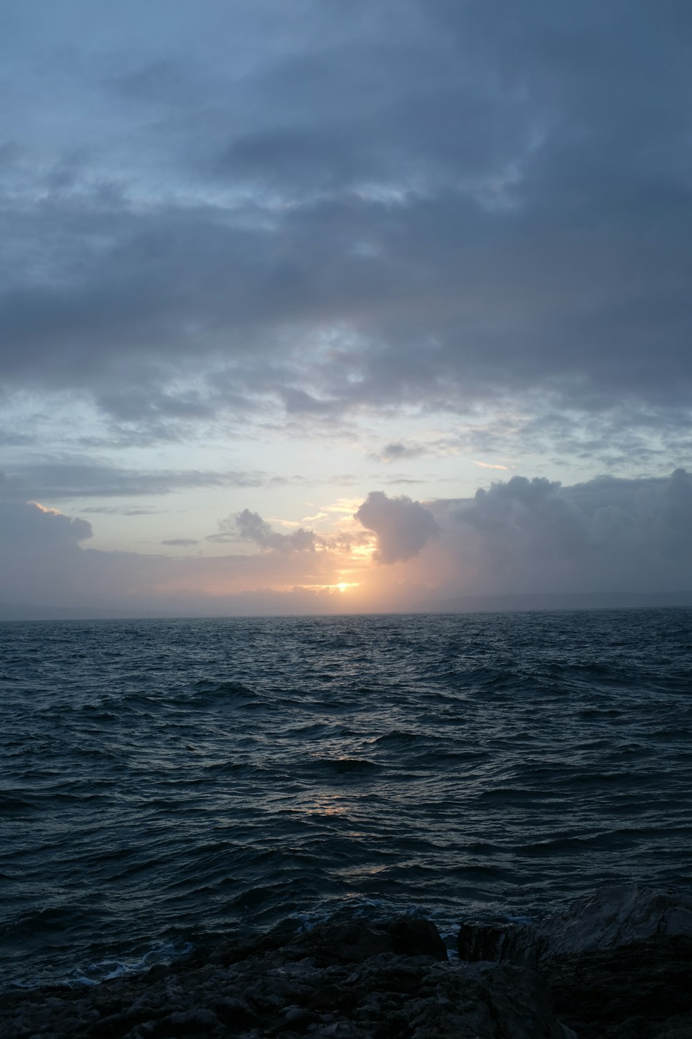 body of water under cloudy sky during daytime