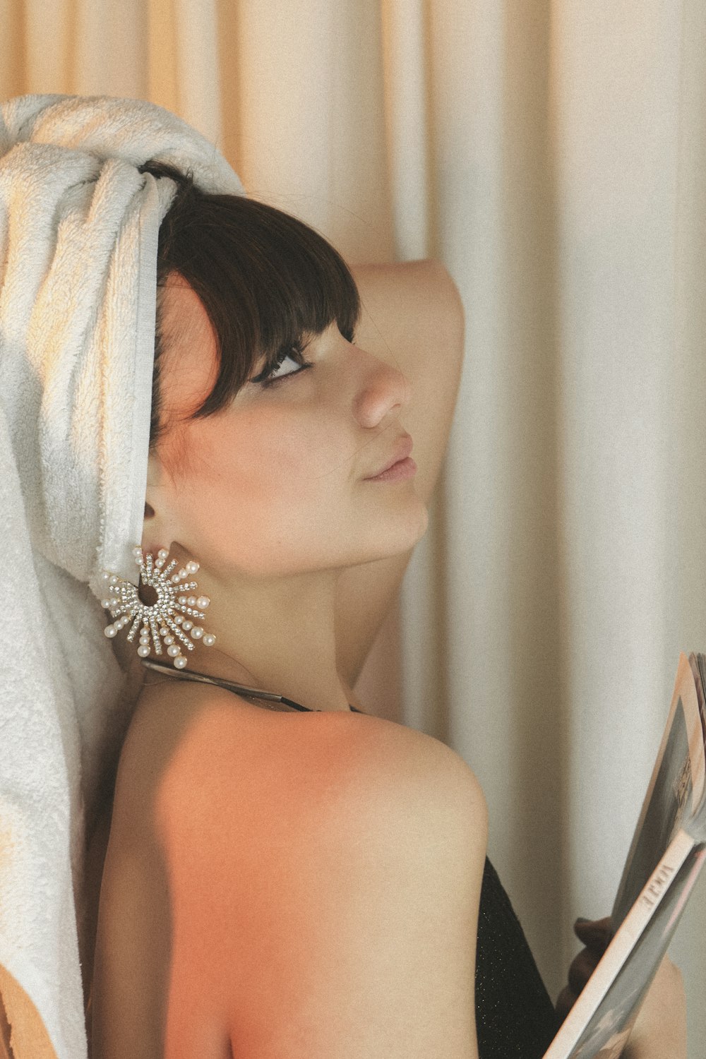 woman in white towel covering her face