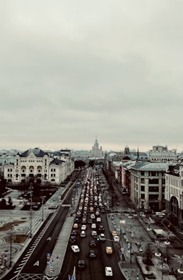 An aerial view of a city with cars driving on busy streets.