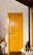 brown wooden door beside green plant