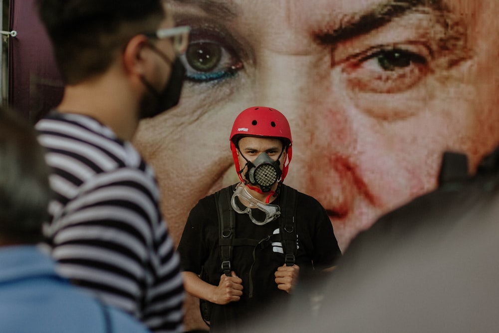 man in black and white stripe shirt with red mask