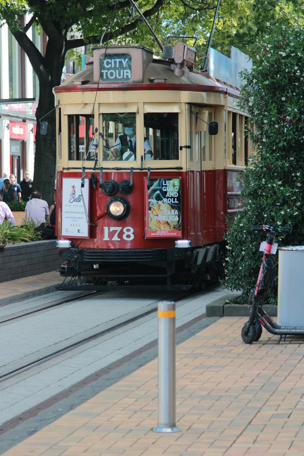 red and white tram on road during daytime