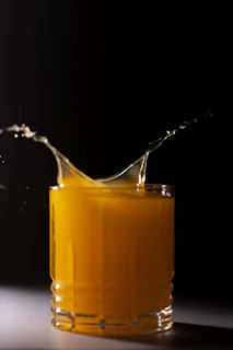orange juice in clear drinking glass