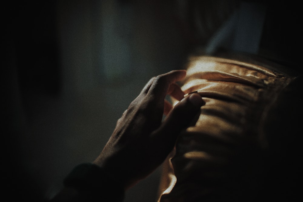 persons hand on black textile