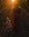 woman in black sleeveless dress holding girl in pink dress