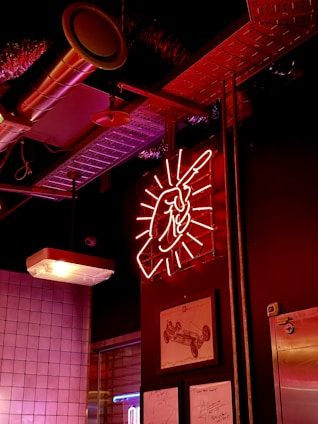 A sleek workshop scene showing vibrant orange and black signage being crafted with precision.