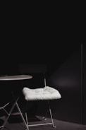Minimalist miniature furniture displayed in a bright room setting.
