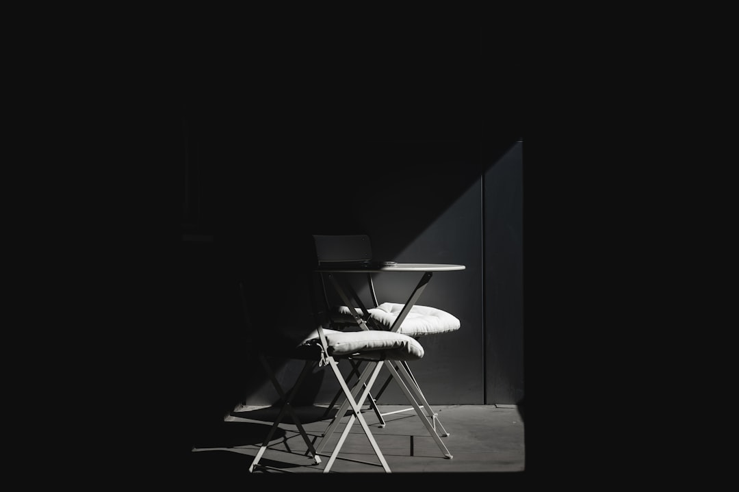 white and black chair on brown wooden table