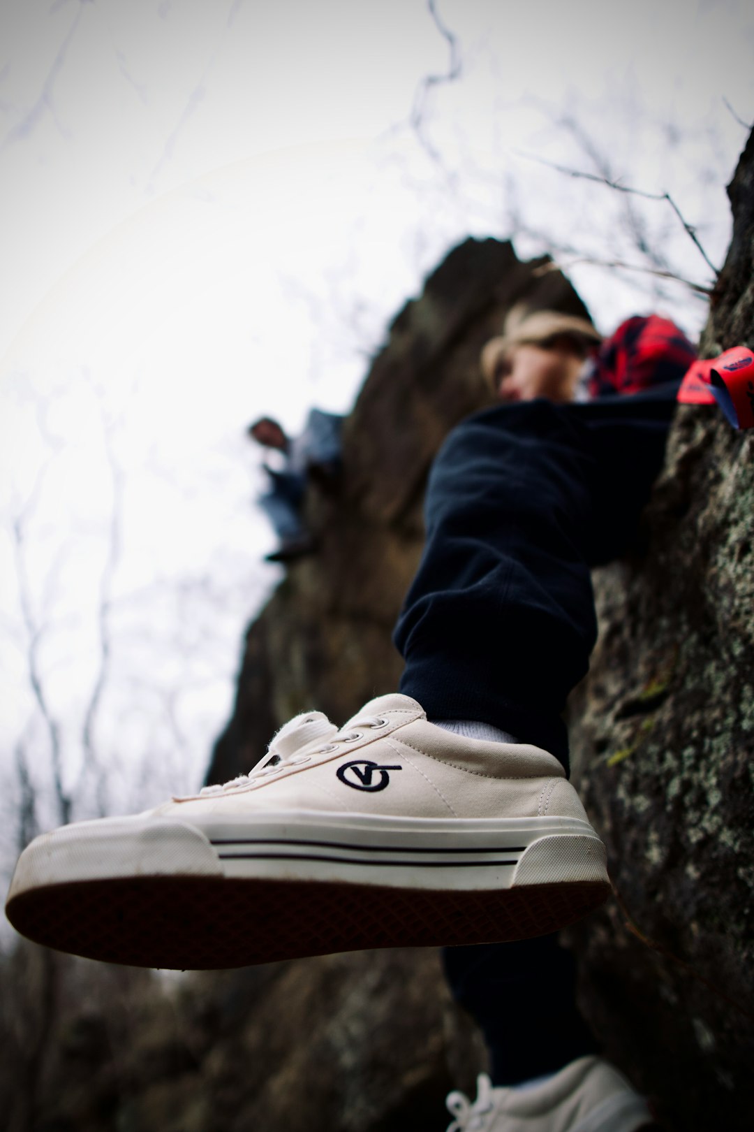 person in black pants and white nike sneakers