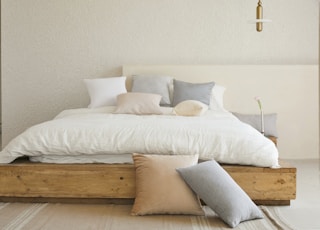 white bed pillow on brown wooden bed frame
