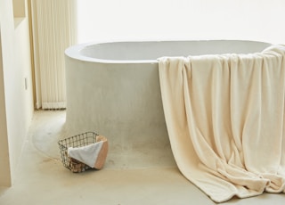 white bathtub with white towel