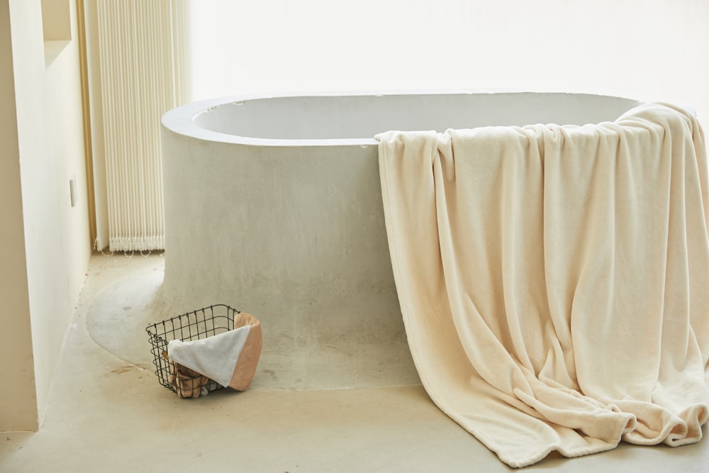 white bathtub with white towel