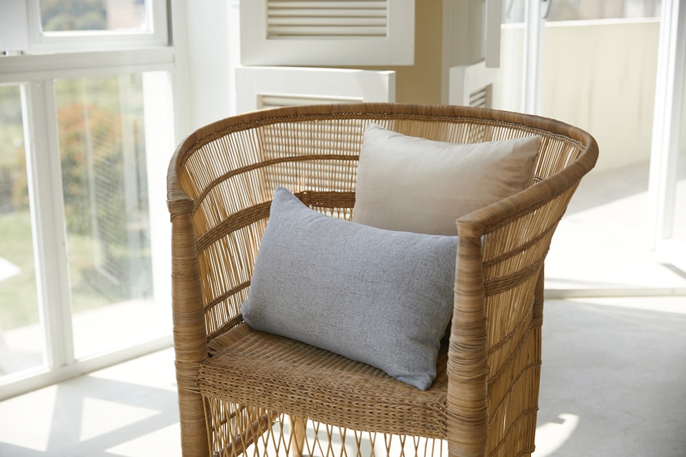 brown wicker armchair with gray throw pillow