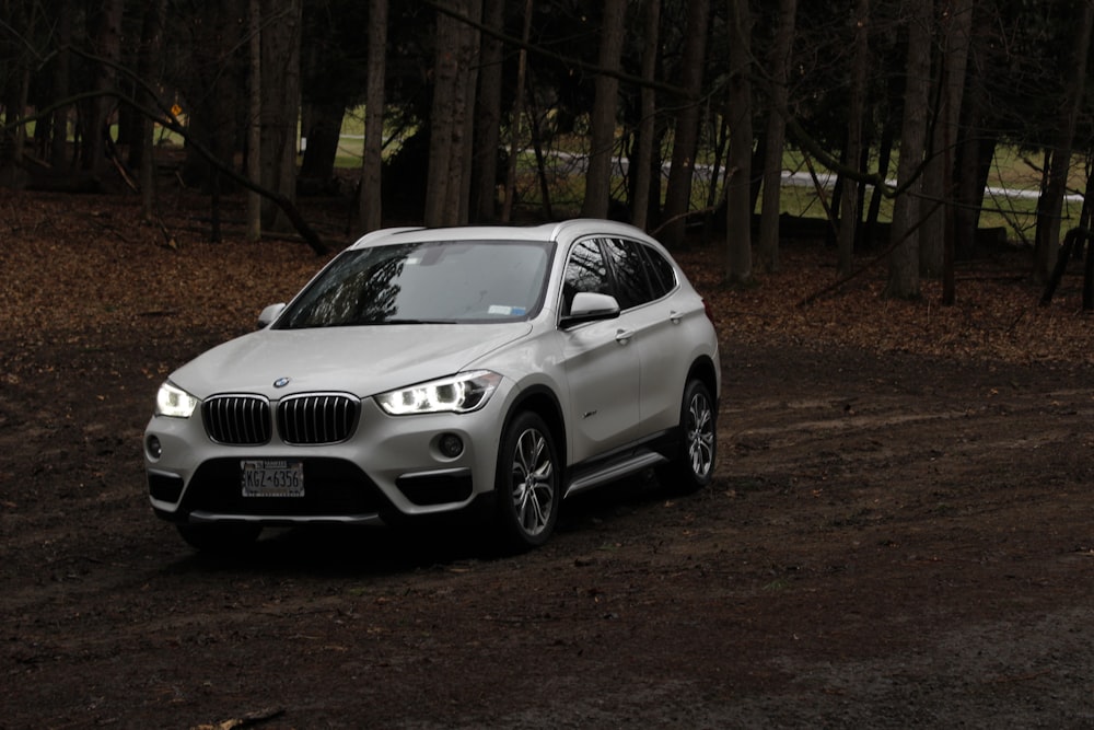 white bmw m 3 coupe parked on brown soil